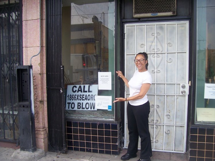 Lynn in front of the hair salon by the Complex